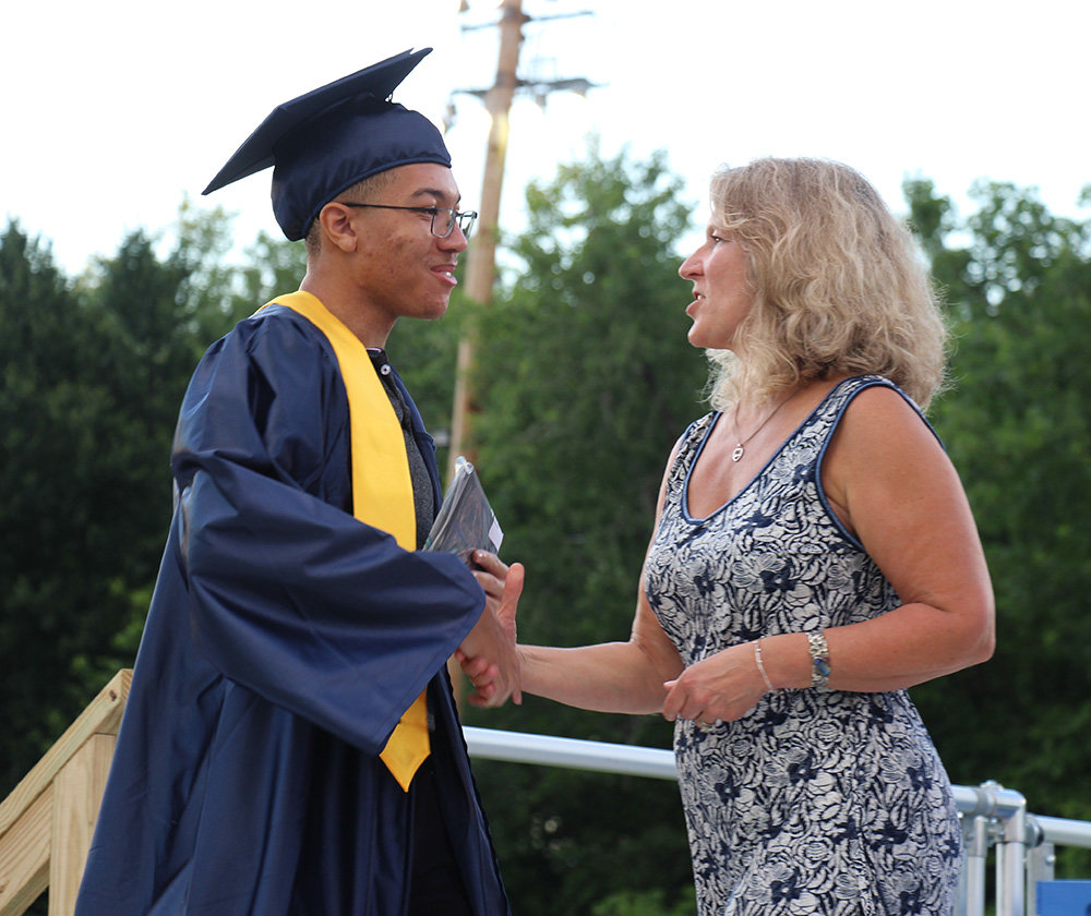 Pine Bush Board of Education President Gretchen Meier greets a graduate during Friday night’s commencement ceremony at Pine Bush High School.